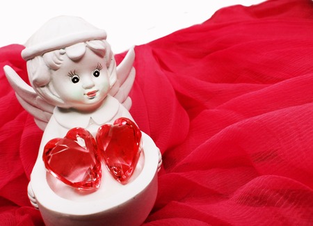 gem crystal heart in angel's hands on silky cloth love conceptの写真素材