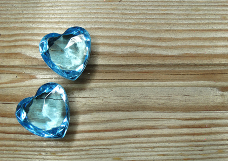 sapphire gem hearts on old wood background love conceptの写真素材