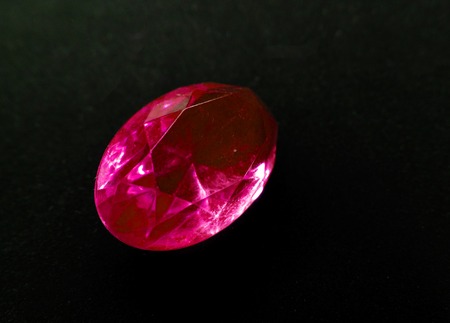 red ruby gem crystal precious jewel on black backgroundの写真素材