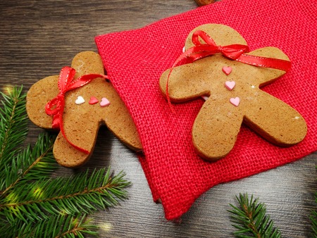 christmas cookies and gingerbread traditional food on wooden board fir branchesの写真素材