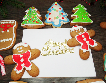 christmas cookies and letter paper with copy space on wooden background