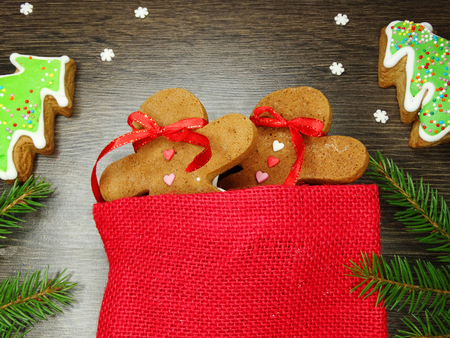 christmas cookies and gingerbread traditional food on wooden board fir branchesの写真素材