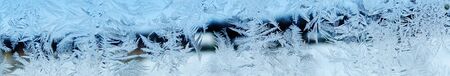 snowflakes ice pattern with sunlight on winter window glass