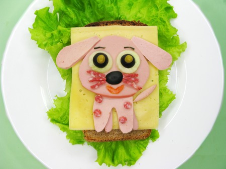 creative sandwich snack with sausage and cheese for child dog formの写真素材