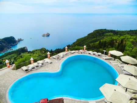 swimmong-pool over blue lagoon beach coast in the ionian sea landscape on Corfu islandのeditorial素材