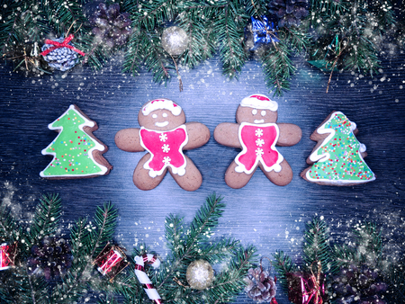 christmas cookies and gingerbread traditional food on wooden board fir branches 
