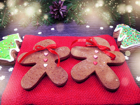 christmas cookies and gingerbread traditional food on wooden board fir branches 