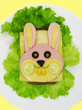 creative sandwich snack with sausage and cheese for child hare formの写真素材