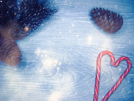 christmas background and decoration with fir branches garland lights on old wooden board