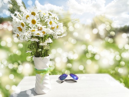 sunglasses daisy flowers and hat summer holiday background conceptの写真素材