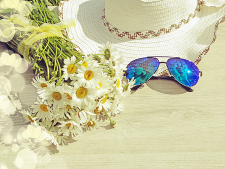 sunglasses daisy flowers and hat summer holiday background conceptの写真素材