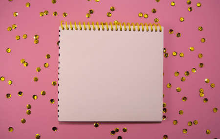 Festive decorations and notebook with golden sequins, flat lay style. Planning concept.の写真素材