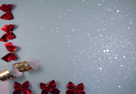 Holiday composition: red bows and gold ribbon on a blue background. Christmas composition. Top view and flat layの写真素材