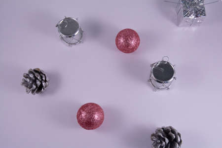 Christmas toy: pink ball, silver gift, drums and cone on a white background. Holiday concept. Top view and flat layの写真素材