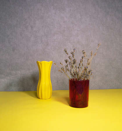 Dried natural flower in a plastic vase and vaseの写真素材