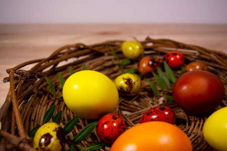 Easter eggs in a basket on wooden backgroundの写真素材