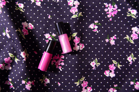 Pink lipsticks on floral backgroundの写真素材