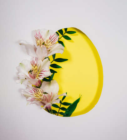 Design for Easter and other holidays. Cutted frame of paper and natural flowers and plants. Design for your holiday and spring projects. Paper art.の写真素材