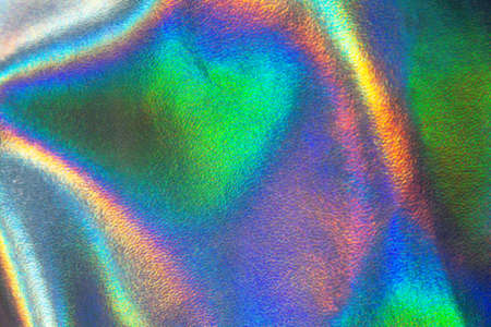 Holographic rainbow iridescent wrinkled background. Abstract and blurred backdrop for your ideas