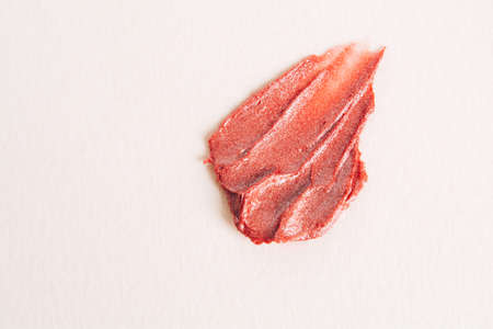 A smear of nude lipstick on a light background