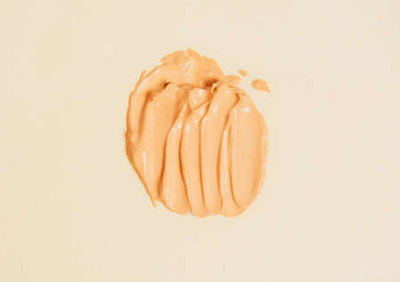 A smear of liquid foundation on a light backgroundの写真素材