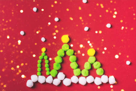 Christmas tree made of pompons with sparkle, art decoration. Space for text