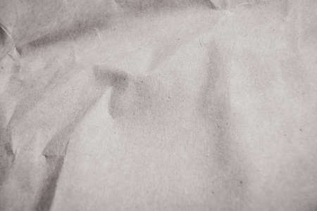 Crumpled black and white paper texture. Paper background, parchment sheet. Copy space