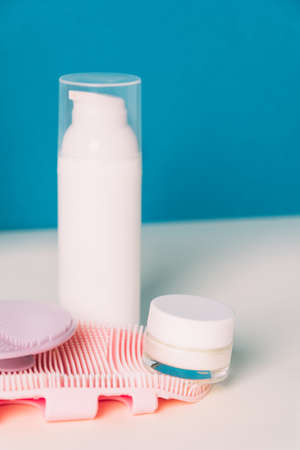 Cosmetic products and silicone facial cleansing brushe. Accessories for beauty treatments, facial cleansing brush. Front viewの写真素材