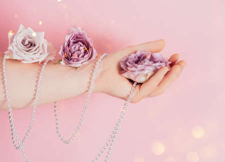 Pink flower, roses in a man's hand. Male beauty and health concept, selfcare trendの写真素材