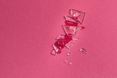 A smear of a clear liquid cosmetic product on a broken glass surface. Beauty and medicine concept. Top view, copy space, verticalの写真素材