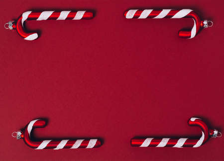 Red baubles of Christmas decoration on a red background. Minimalistic style. Layout for the holiday. Top view, flat layの写真素材