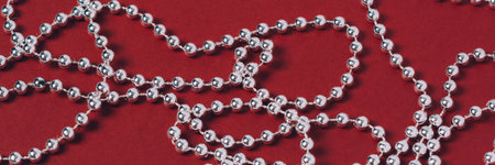 Banner. Silver holiday decorations on a red background. Backdrop for your festive ideas....