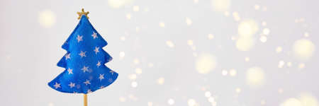Christmas tree made of blue felt on a white backgroundの写真素材