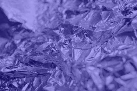 Textured background of crumpled metal glittering foil. Abstract backdrop for your projects. Copy...