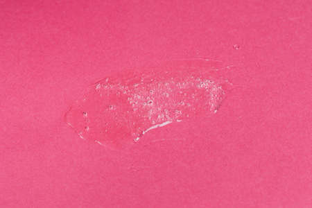Liquid gel cosmetic product with bubbles on pink background. Texture and backgroundの写真素材