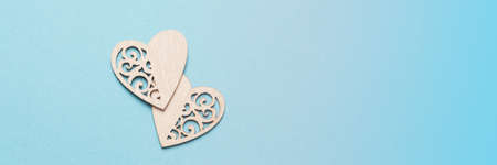 Banner with wooden hearts. Background for the holiday of Valentine's Day. The concept of love, romance and tendernessの写真素材