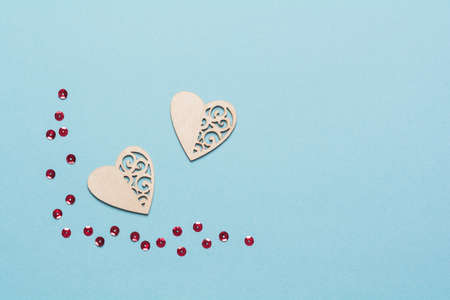 Wooden hearts with glitter. Background for the holiday of Valentine's Day. The concept of love, romance and tenderness. copy spaceの写真素材