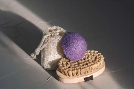 Eco friendly bathroom accessories on gray texture background. Beauty, sustainable and wellness...