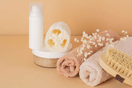 Spa cosmetic products and eco friendly bathroom accessories on a beige background. Beauty, spa and wellness conceptの写真素材