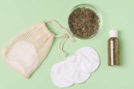 Fermented beauty product with green tea extract and eco friendly accessories, holistic beauty concept, flat layの写真素材