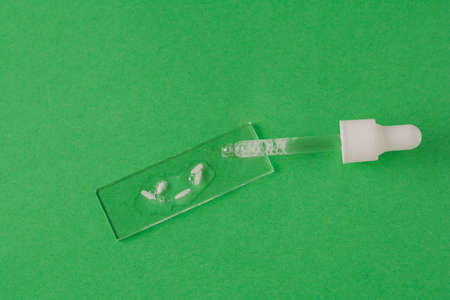 Making rice water for skin care face. Pipette and rice on medical glassの写真素材