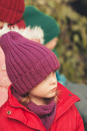 Pensive and serious child outdoors on nature background. child portrait looking to the sideの写真素材