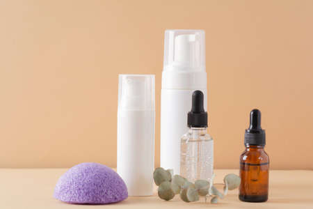 Facial cosmetic products and konjac sponge on a beige backgroundの写真素材