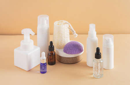 Facial cosmetic products and konjac sponge on a beige backgroundの写真素材