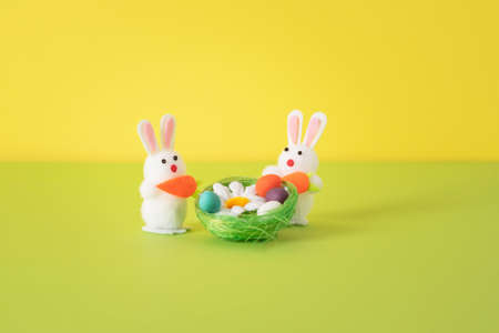 Easter composition with decorative rabbits and eggs in the nest. Background for your project for the...