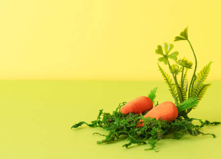 Easter composition with decorative carrots for Easter bunnies and natural materials. Background for your project for the holiday happy easterの写真素材