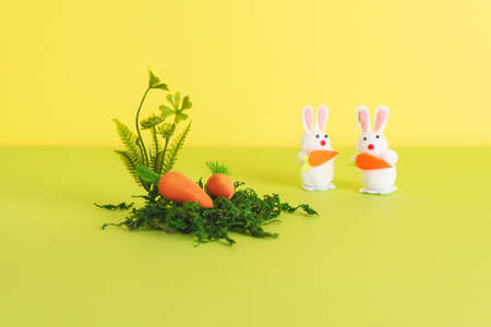 Easter composition with decorative carrots for Easter bunnies and natural materials. Background for your project for the holiday happy easterの写真素材