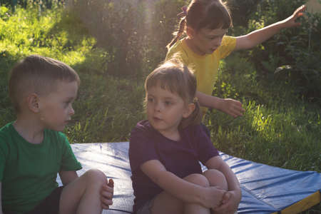 Children spend their leisure time outdoors. Communication of preschoolers. The concept of childhood friendship, interaction and supportの写真素材