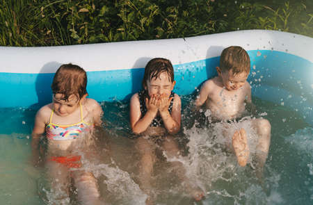 Cheerful happy children in swimming pool. Summer timeの写真素材