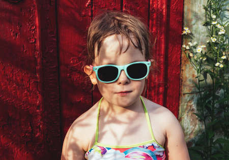 Portrait of a child in sunglasses and a bathing suit